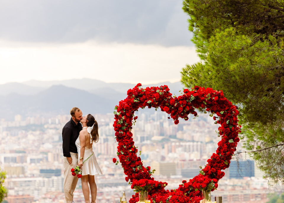 A romantic proposal at Montjuïc featuring a giant XXL heart, with the newly engaged couple sharing a kiss overlooking Barcelona.