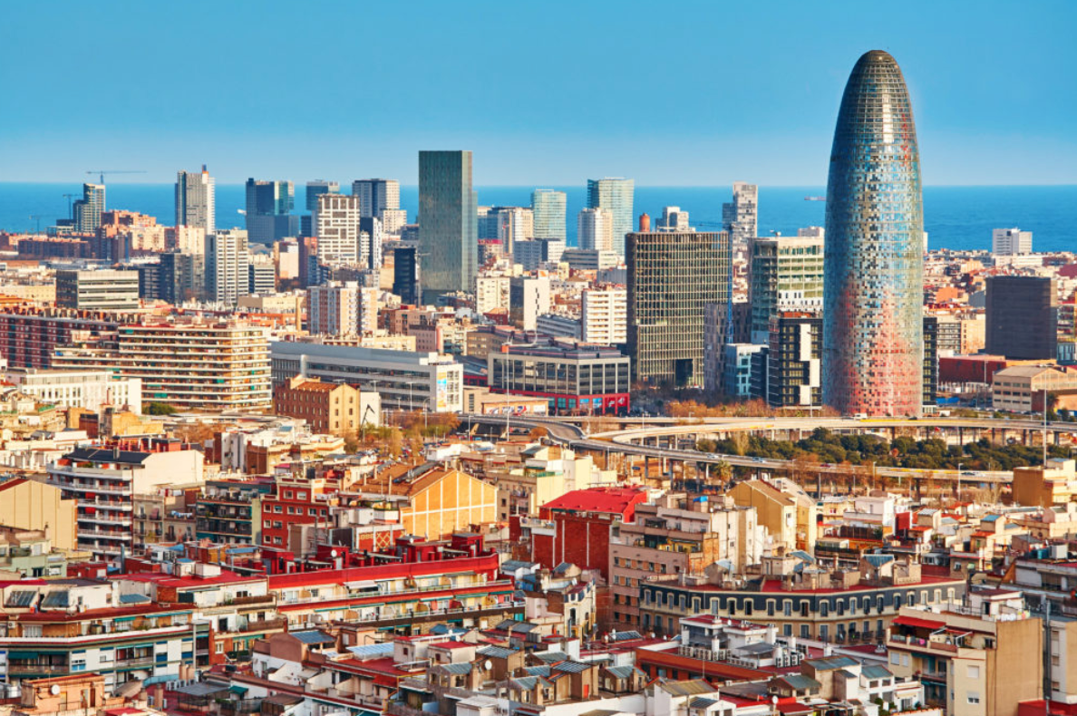 Barcelona city skyline with iconic buildings and urban architecture under a clear Mediterranean sky.