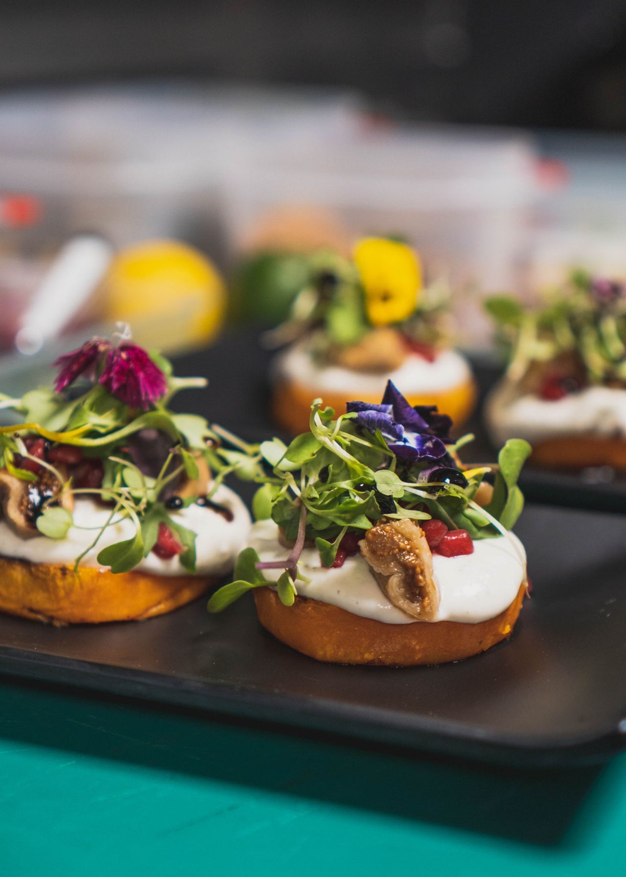 Plated appetizers from our private chef catering with garnishes on a black tray