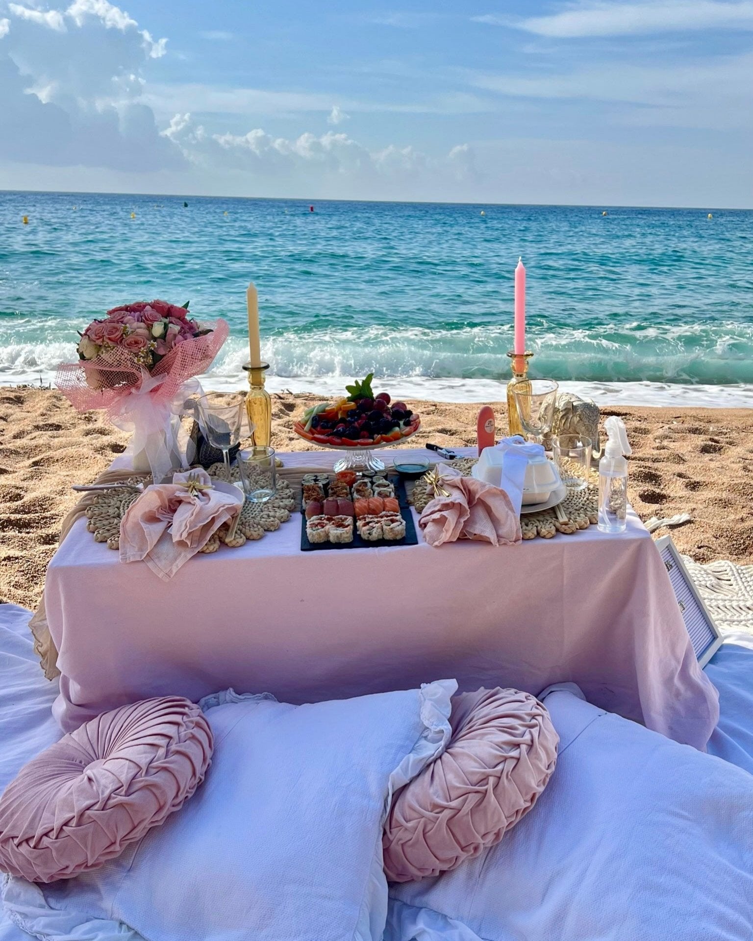 Romantic picnic setup with soft blankets, plush pillows, and a gourmet grazing board under a scenic sunset, creating the perfect atmosphere for a couple's outdoor date in Barcelona.