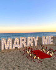 Enhance your proposal in Marbella with our dazzling XXL Marry Me Letters, creating a magical and romantic backdrop that will make your moment truly unforgettable.