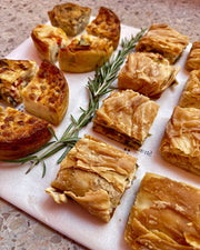 Explore our Pastry Savory Grazing Platters in Barcelona, featuring freshly prepared quiches and pita filos with vegetarian and meat options—perfect for any gathering or event.