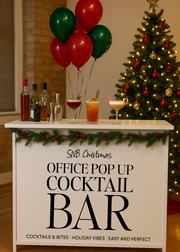 Office pop-up cocktail bar setup with Christmas decorations, including a tree and balloons.