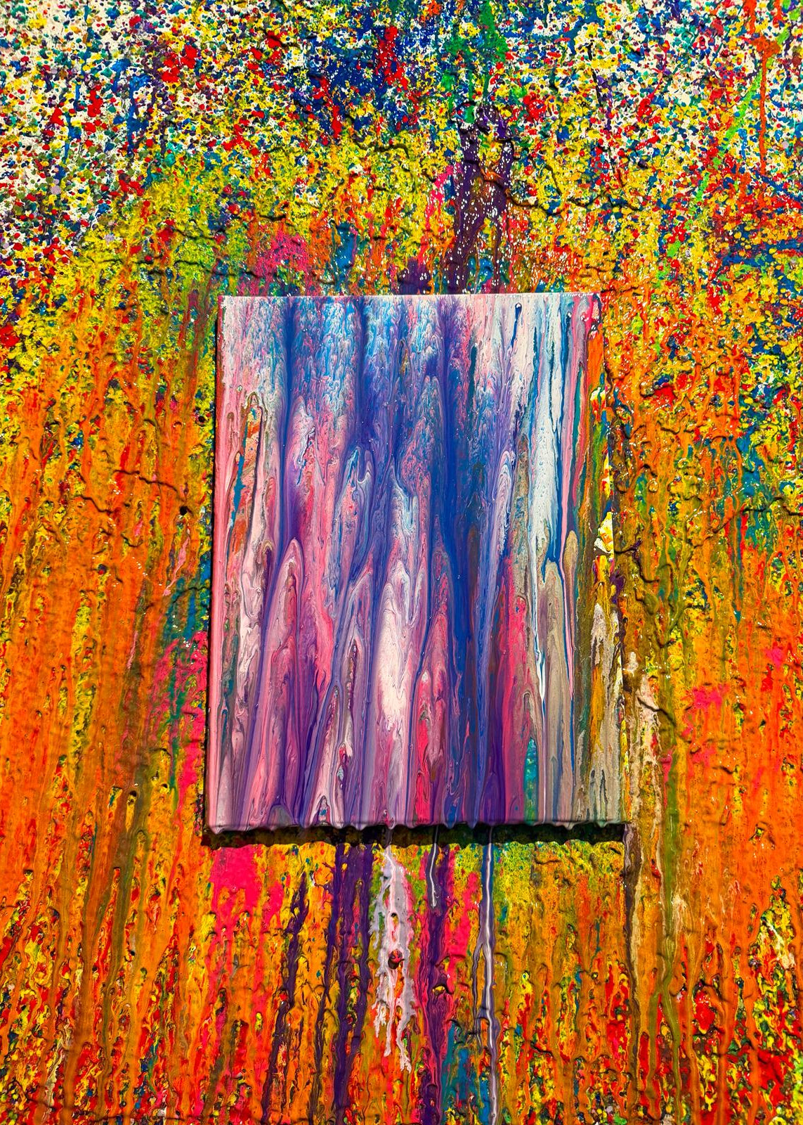 Abstract painting with a smaller rectangular painting on a colorful textured background